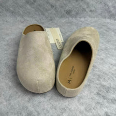 One foot wearing a thick-soled baghdad-style shoe
