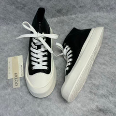High-top black and white canvas shoes with thick soles