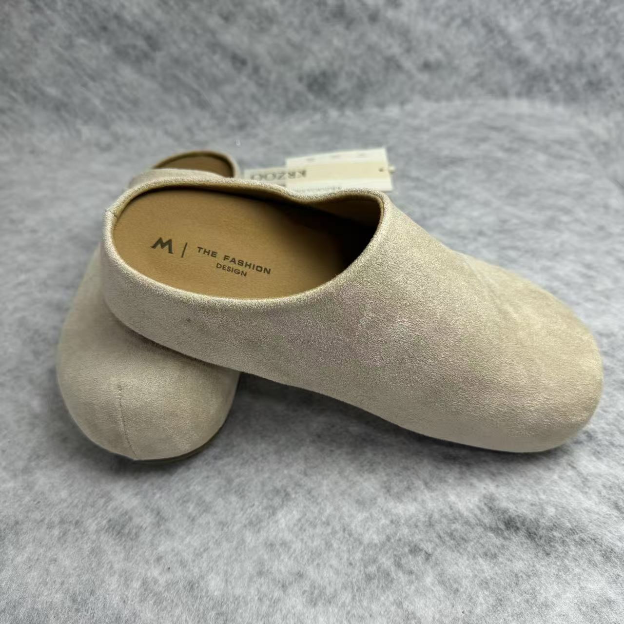 One foot wearing a thick-soled baghdad-style shoe