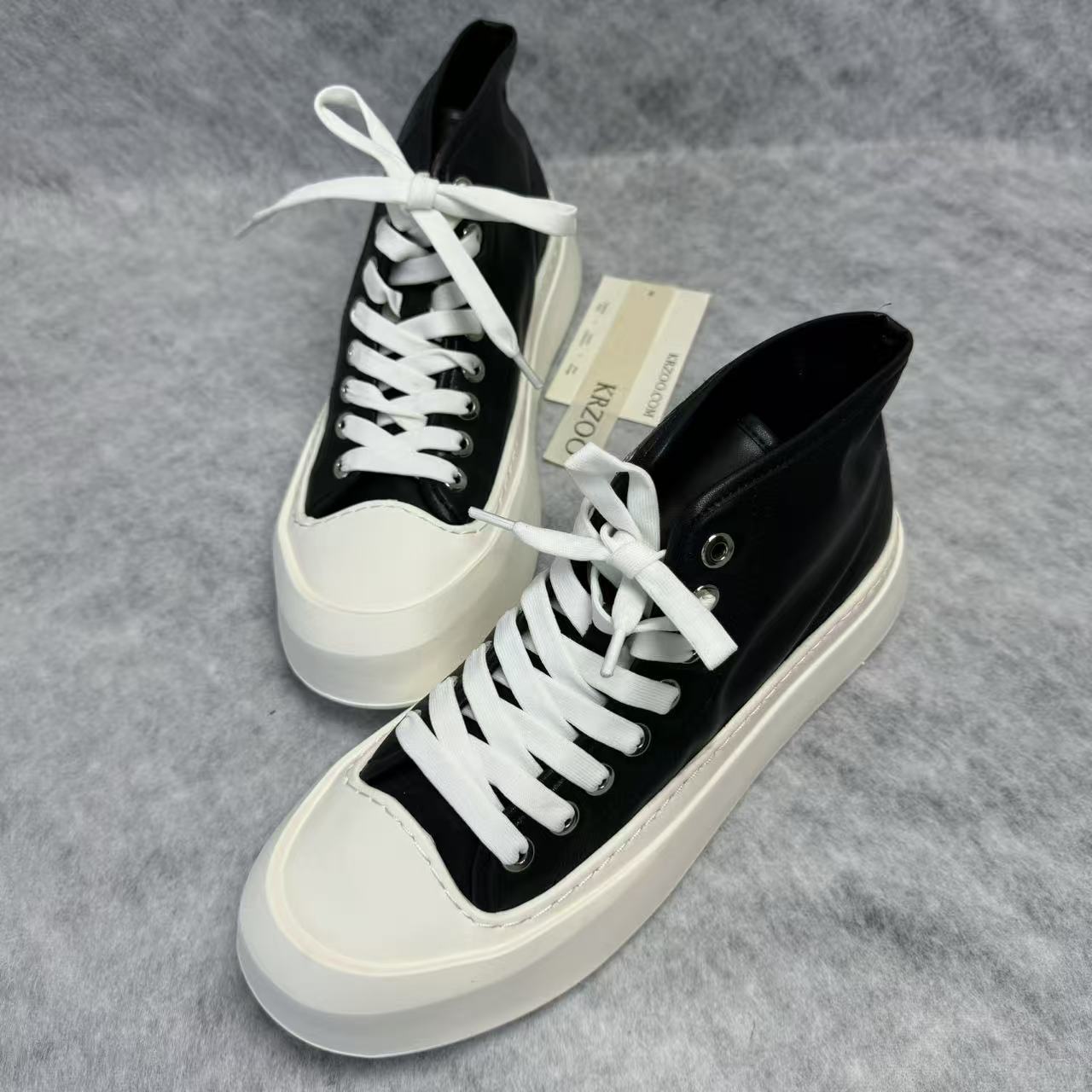High-top black and white canvas shoes with thick soles
