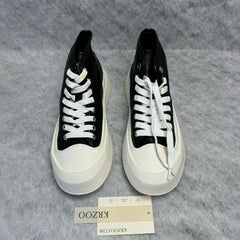 High-top black and white canvas shoes with thick soles