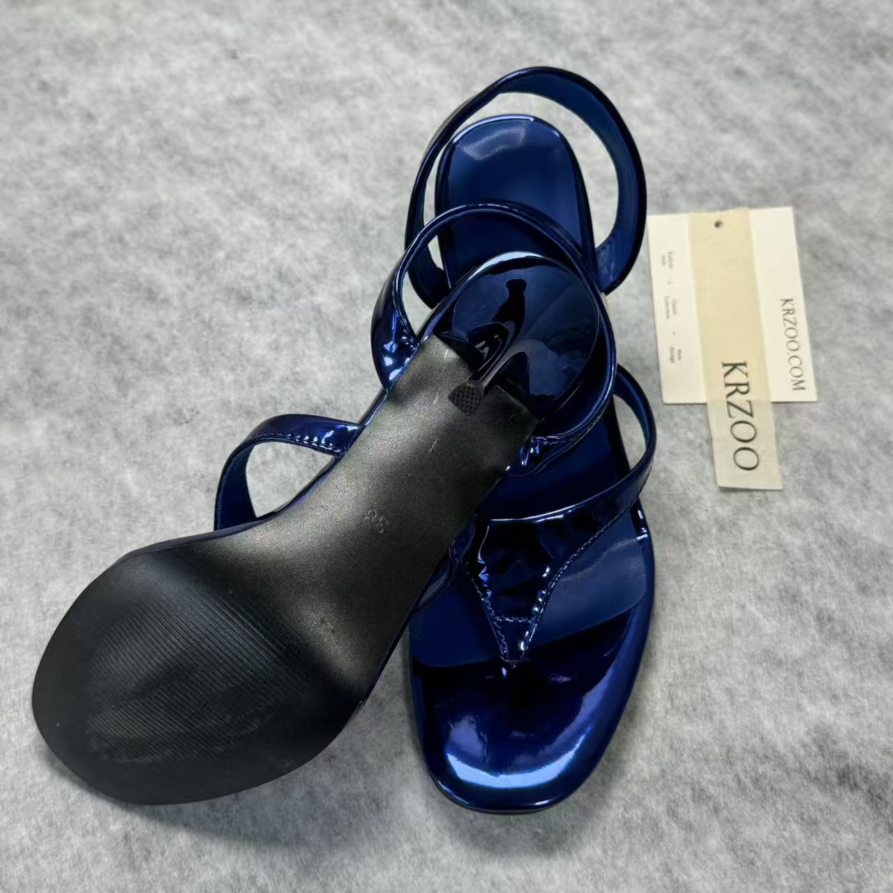 A slip-on toeless open-toe Roman-style shoe