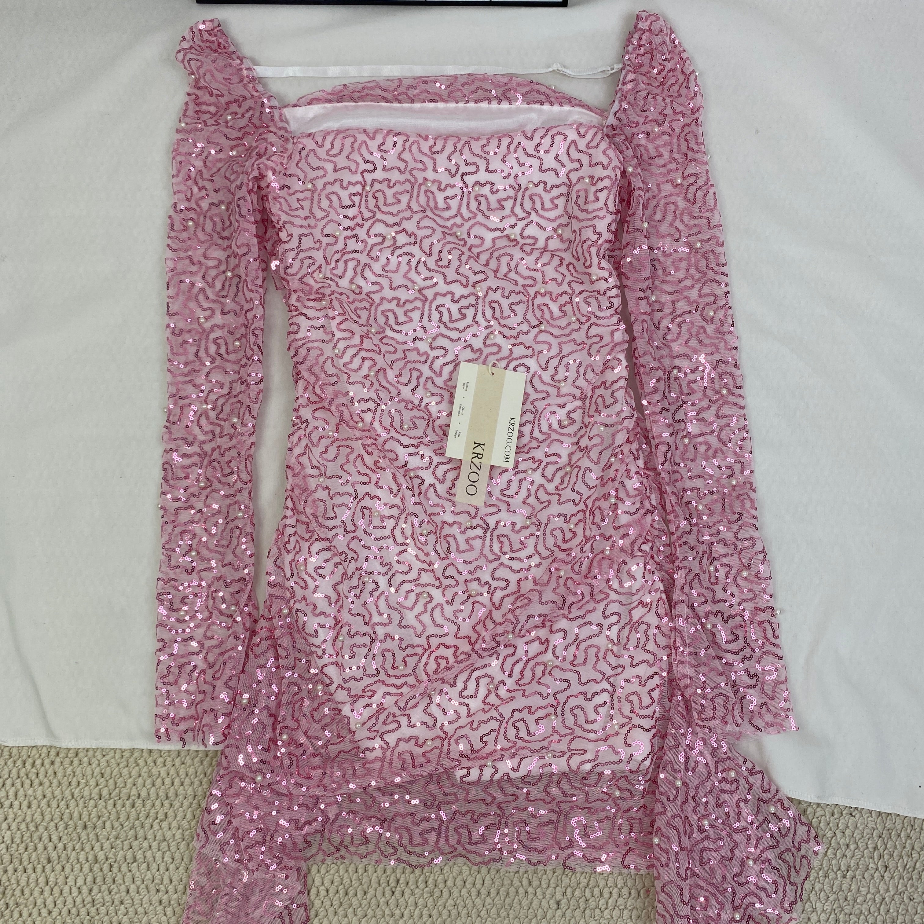 A slimming, soft pink, figure-hugging dress