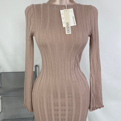 A fitted, ruffled edge knitted long dress
