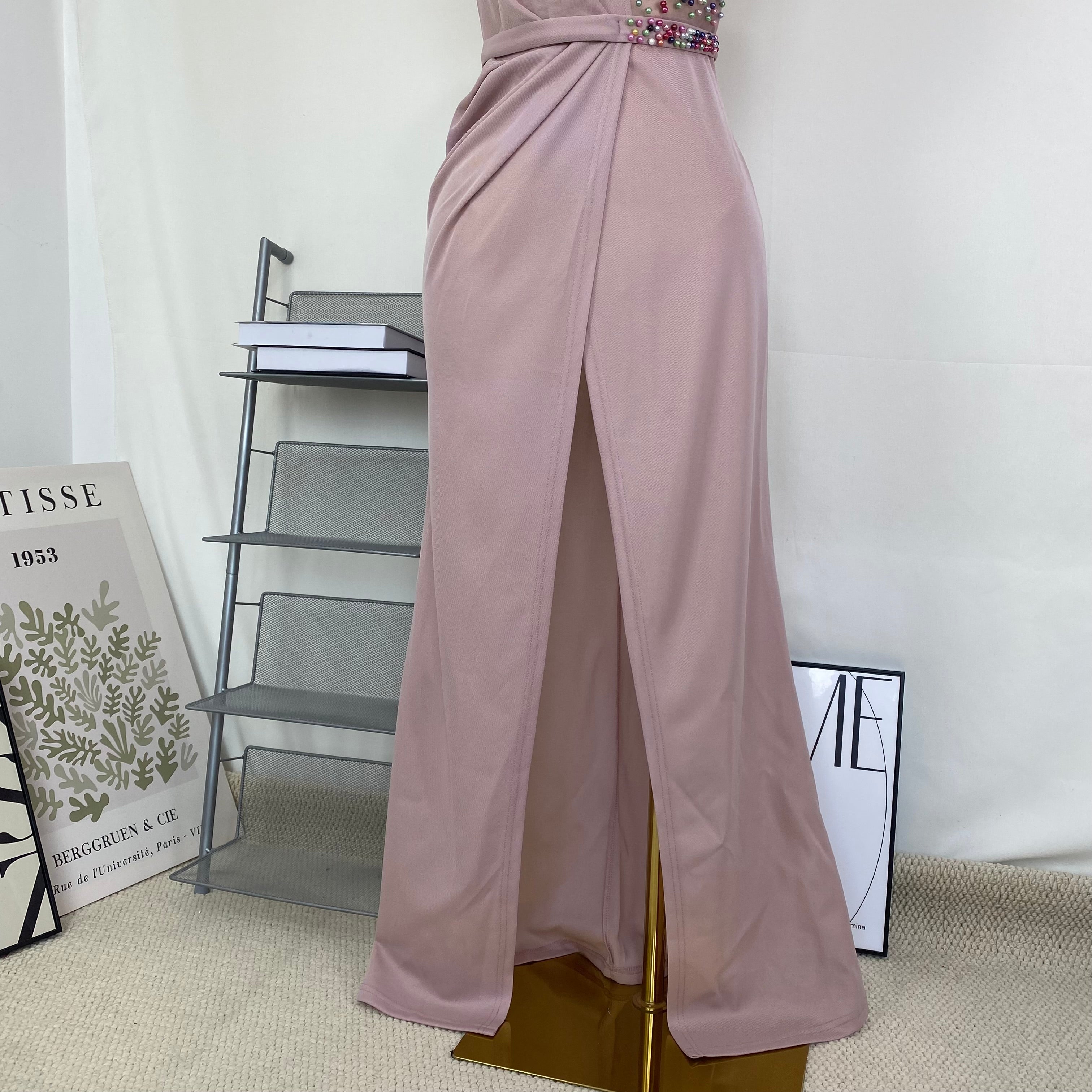 A halter-style and trailing evening dress