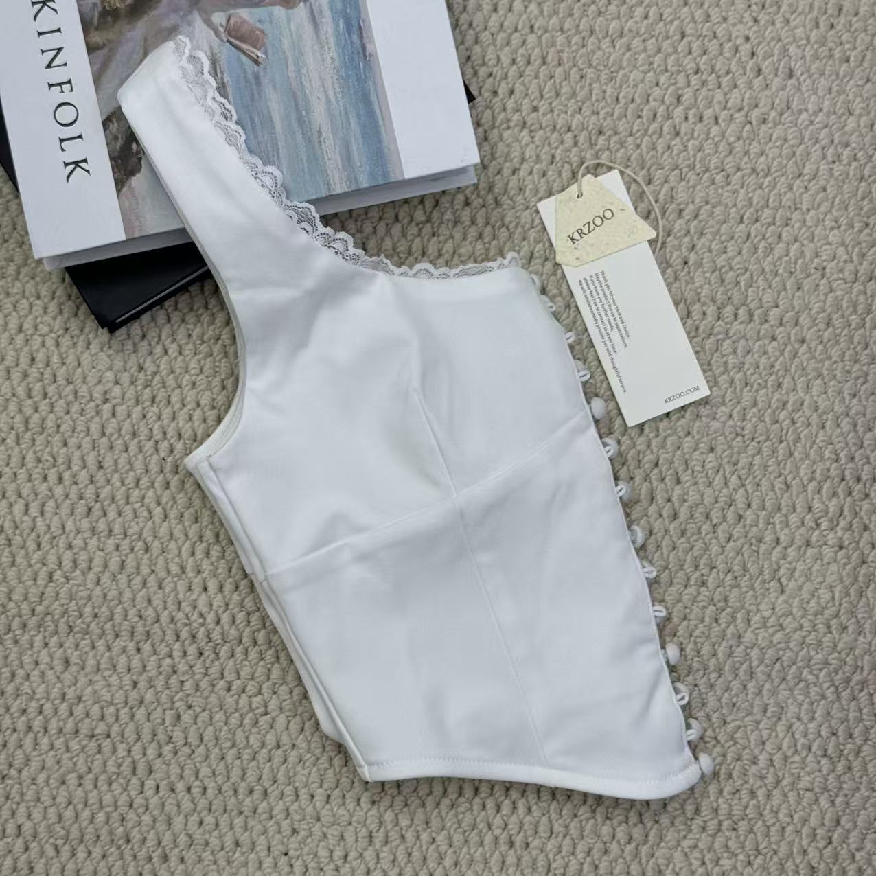 Padded round-necked vest with lace trim
