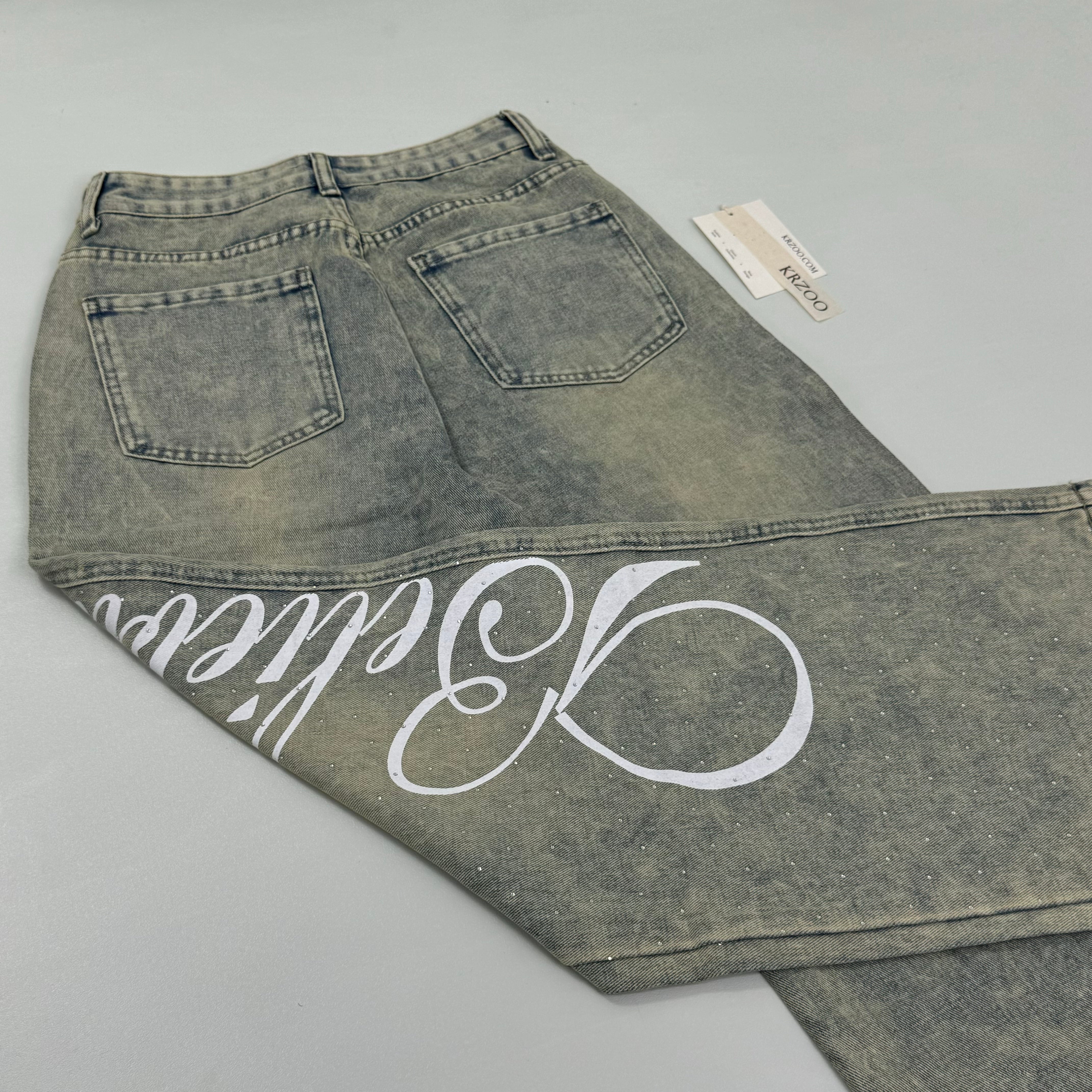 Washed letter-printed sequined denim pants