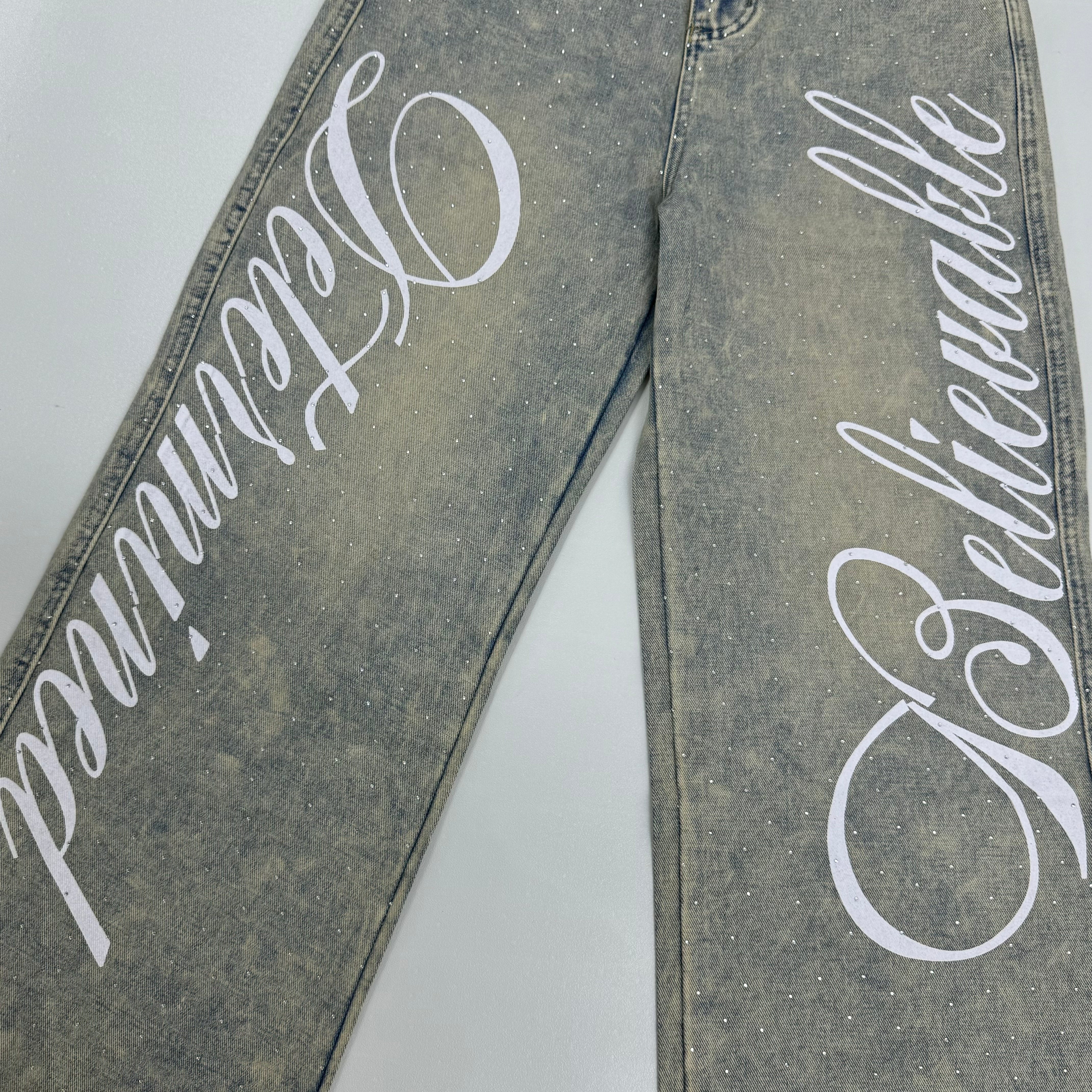 Washed letter-printed sequined denim pants