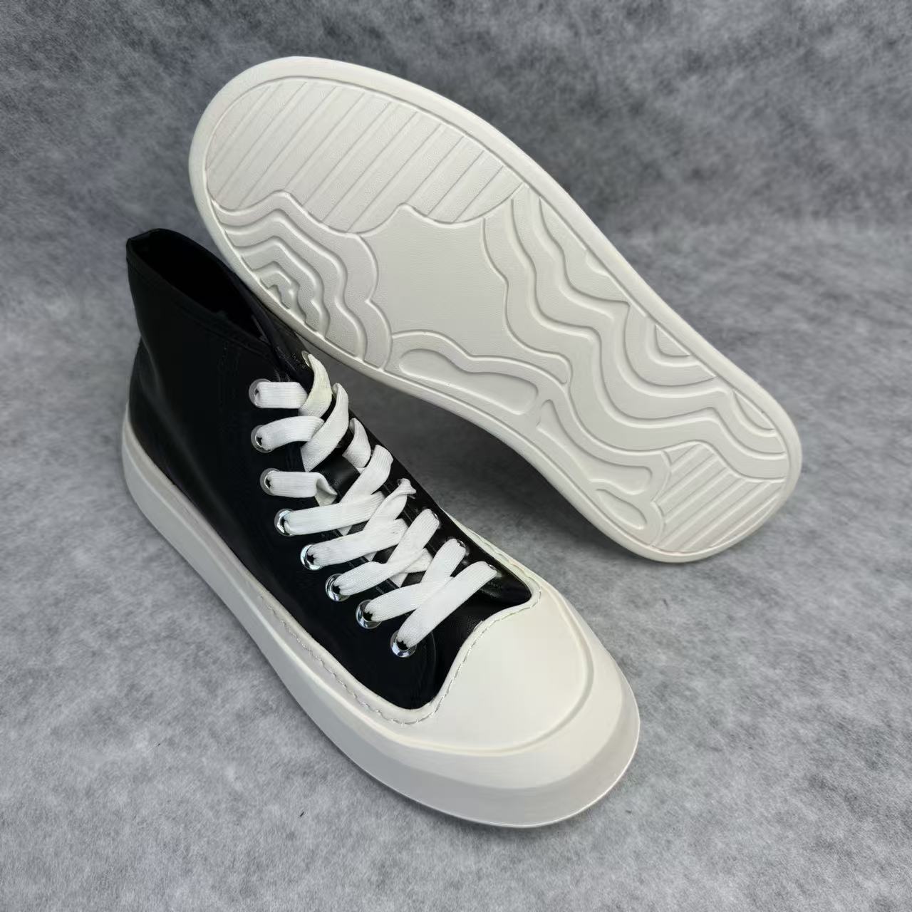 High-top black and white canvas shoes with thick soles