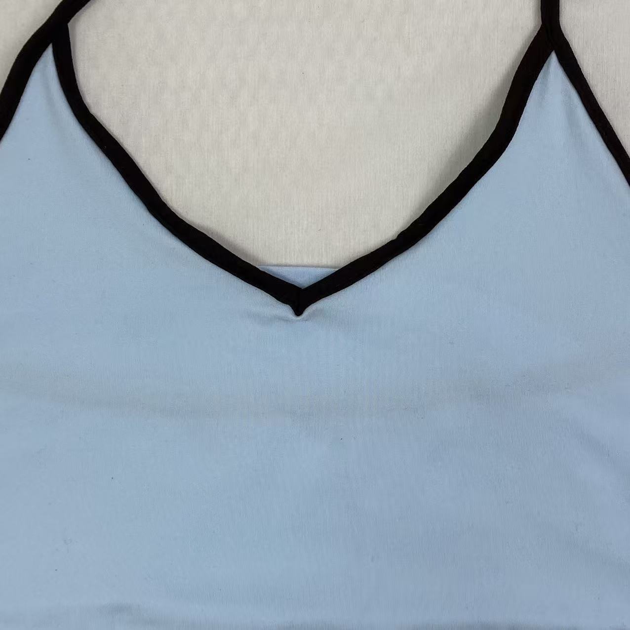 Contrasting color tie-neck sling-neck top