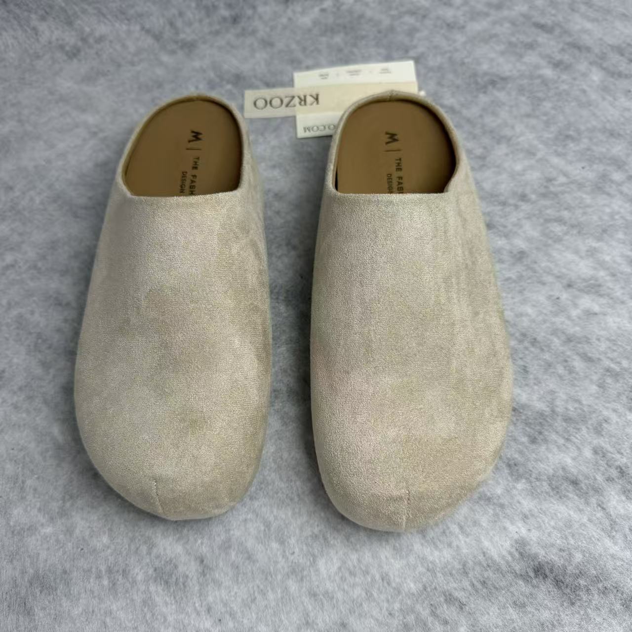 One foot wearing a thick-soled baghdad-style shoe